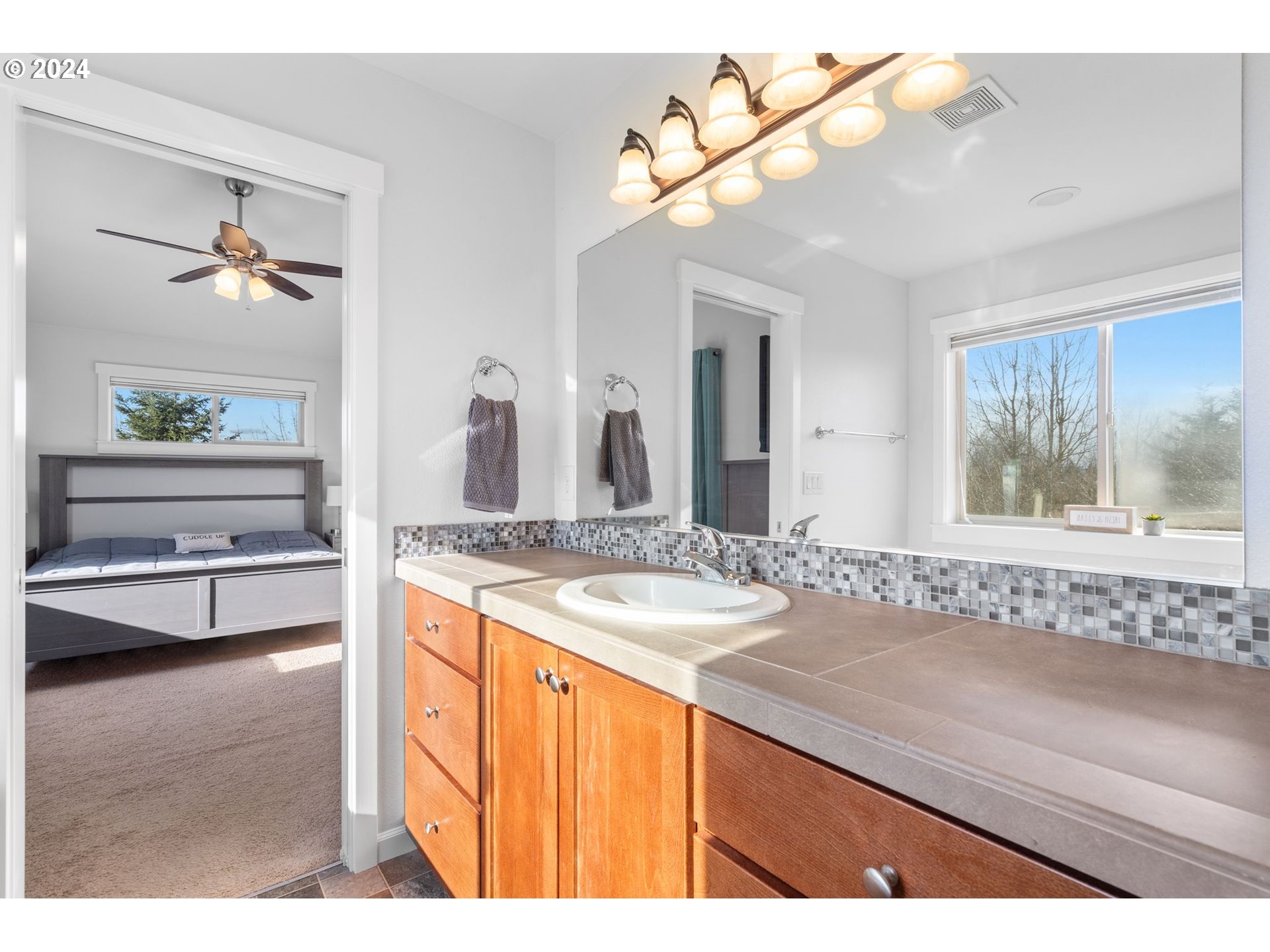 3519 North 6th Circle Ridgefield, WA 98642 - Photo 16 of 40 a bathroom with a granite countertop sink a large mirror and a bathtub