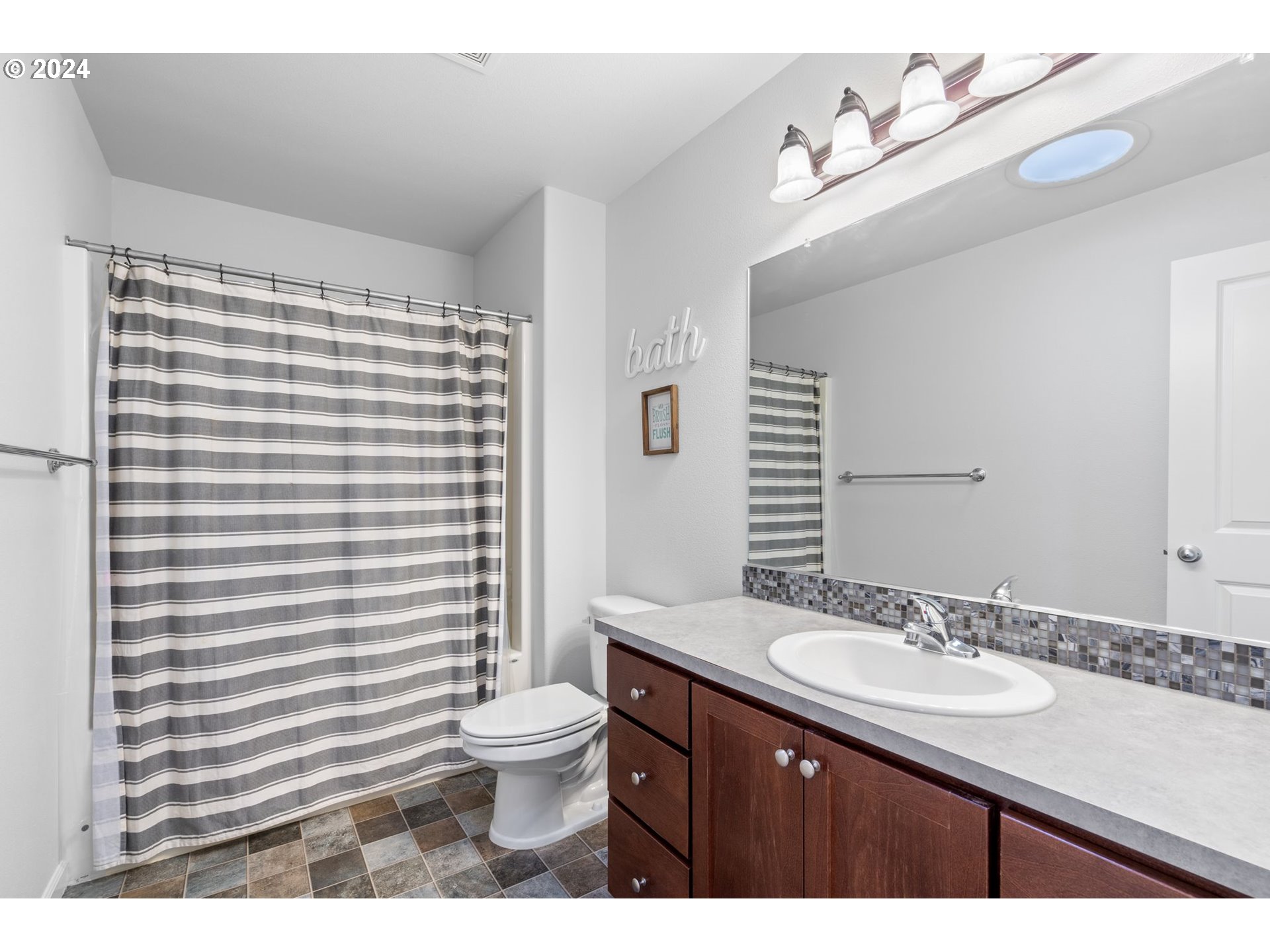 3519 North 6th Circle Ridgefield, WA 98642 - Photo 23 of 40 a bathroom with a sink a toilet and shower