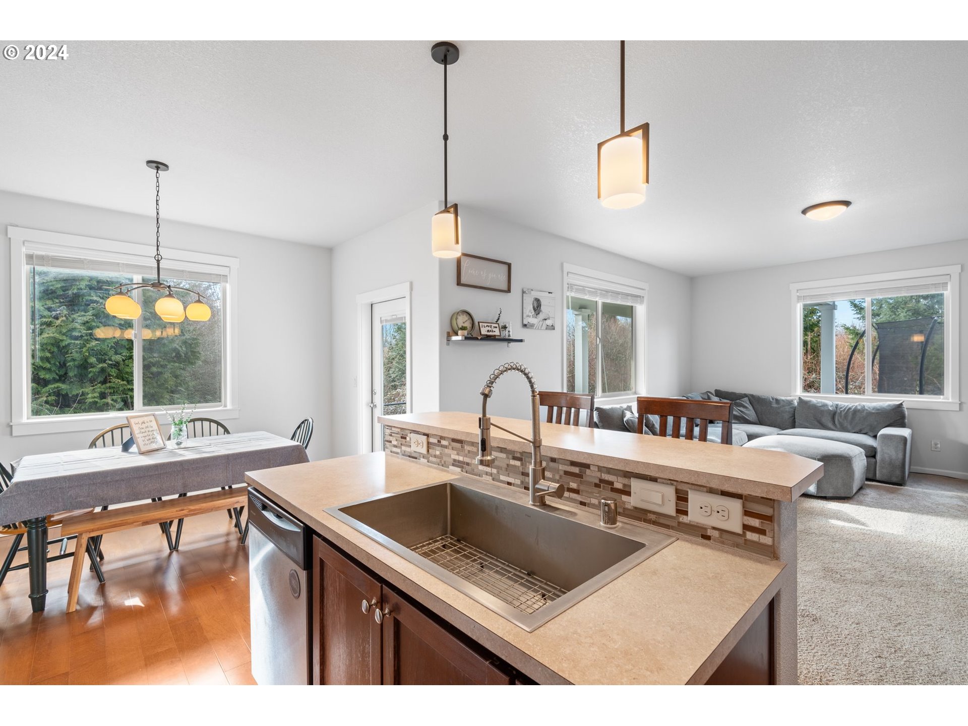 3519 North 6th Circle Ridgefield, WA 98642 - Photo 9 of 40 a kitchen with a stove a sink a dining table and chairs
