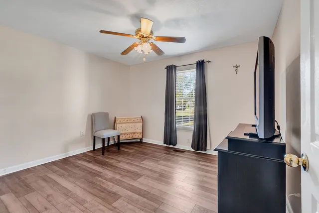 a living room with furniture and wooden floor