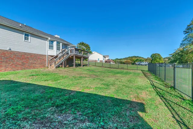 a view of a house with backyard and porch