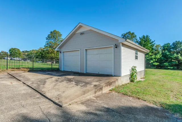 a view of a house with backyard and trees