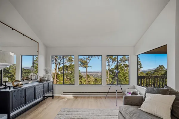 a living room with furniture and large windows