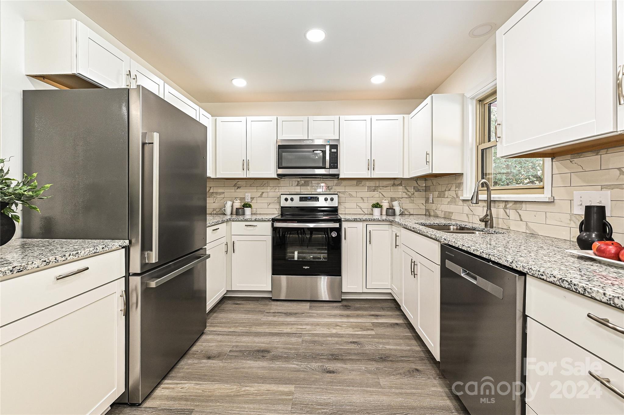 8617 Pine Circle Charlotte, NC 28215 - Photo 9 of 30 a kitchen with a refrigerator stove and sink