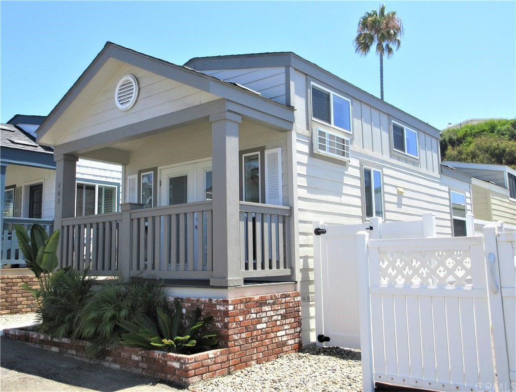 102 Sandy Drive San Clemente, CA 92672 - Photo 2 of 16 a front view of a house with a garden