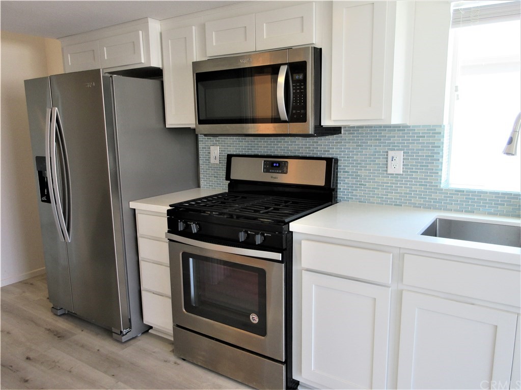 102 Sandy Drive San Clemente, CA 92672 - Photo 4 of 16 a kitchen with a stove microwave and refrigerator