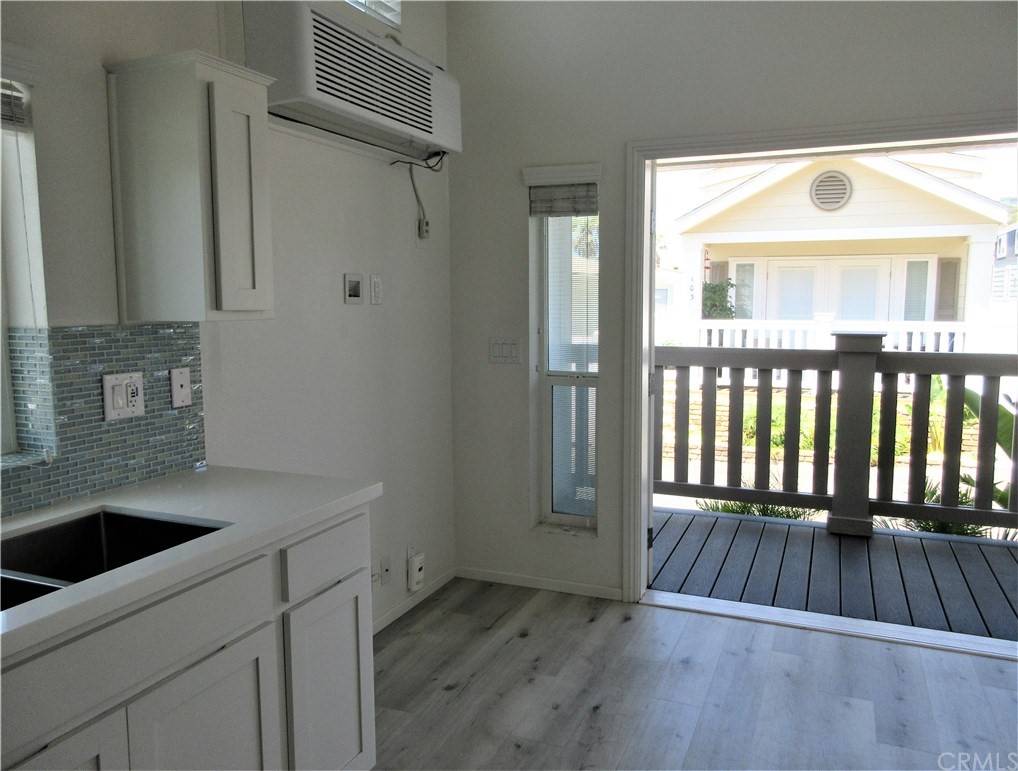 102 Sandy Drive San Clemente, CA 92672 - Photo 5 of 16 a view of a hallway with wooden floor and a sink