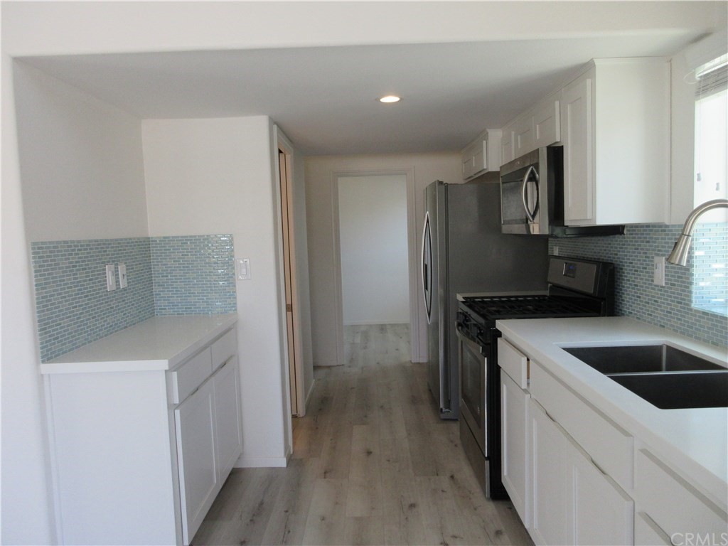 102 Sandy Drive San Clemente, CA 92672 - Photo 8 of 16 a kitchen that has a sink and a stove in it