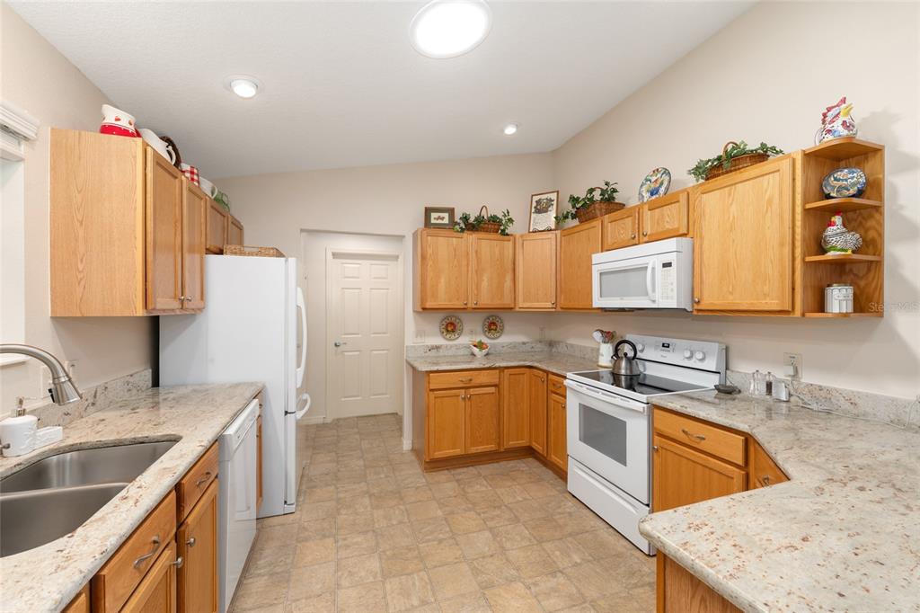 771 Fenwick Loop The Villages, FL 32163 - Photo 19 of 51 a kitchen with a sink stove and cabinets