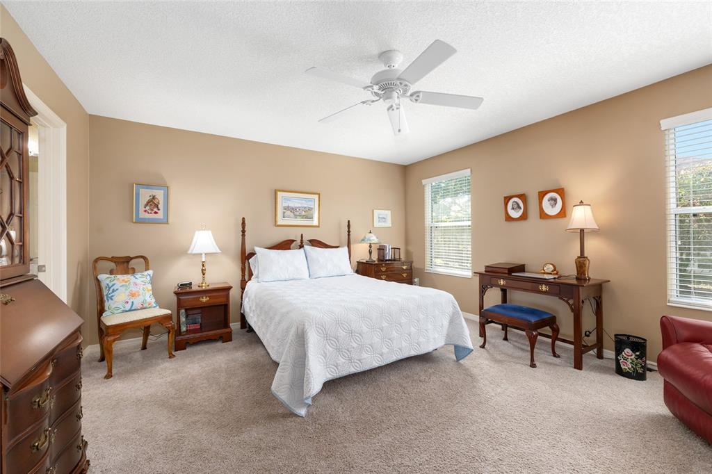 771 Fenwick Loop The Villages, FL 32163 - Photo 25 of 51 a bedroom with a bed and a chandelier