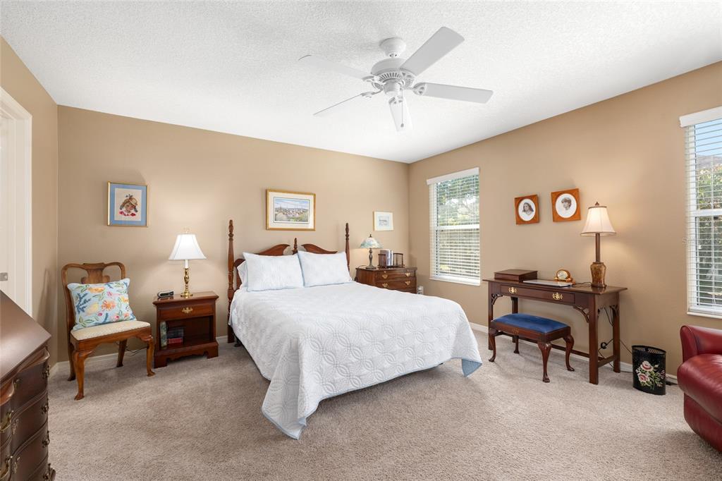 771 Fenwick Loop The Villages, FL 32163 - Photo 26 of 51 a bedroom with a bed and a chandelier