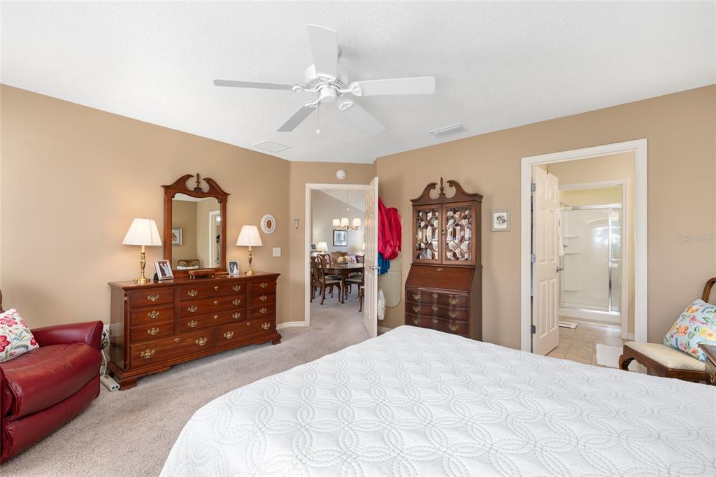 771 Fenwick Loop The Villages, FL 32163 - Photo 28 of 51 a bedroom with a bed and dresser with mirror