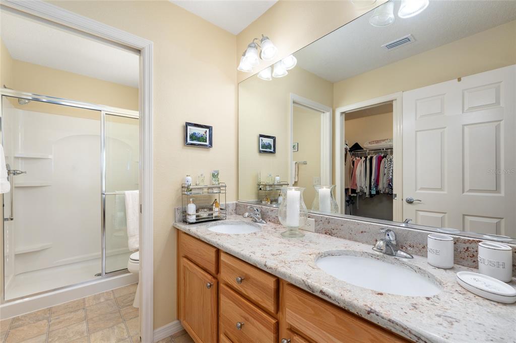 771 Fenwick Loop The Villages, FL 32163 - Photo 29 of 51 a bathroom with a granite countertop sink and a mirror