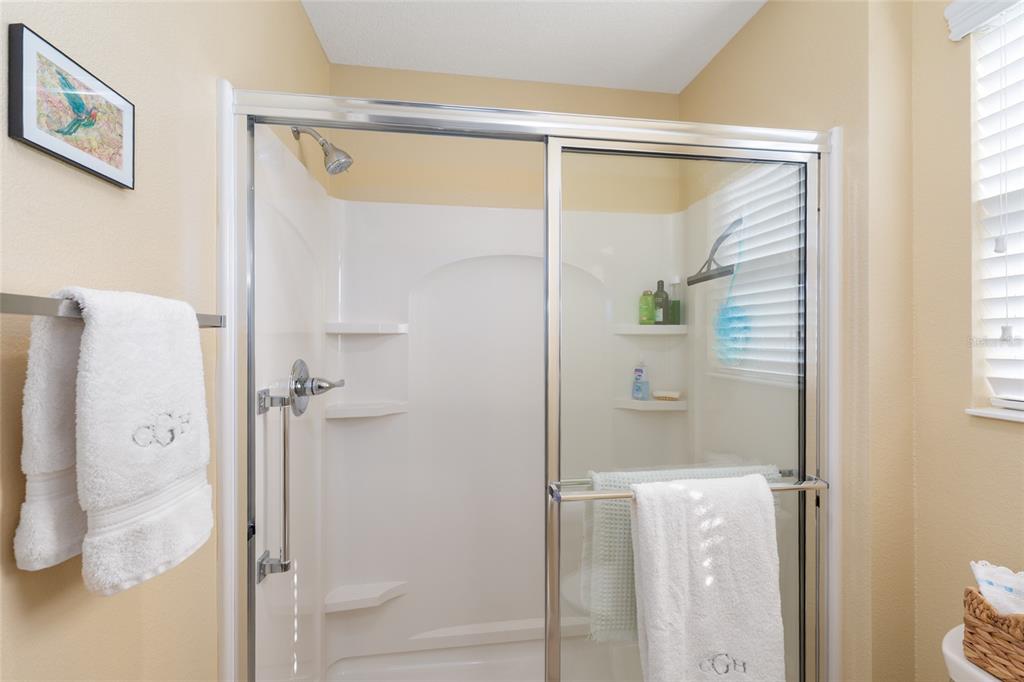 771 Fenwick Loop The Villages, FL 32163 - Photo 31 of 51 a bathroom with a glass shower door