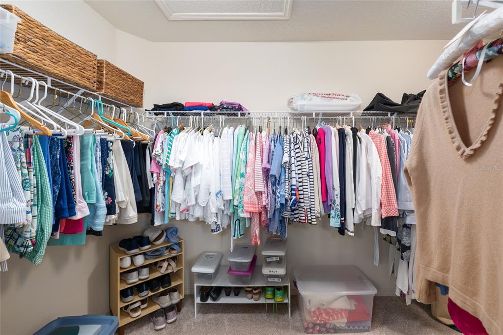 771 Fenwick Loop The Villages, FL 32163 - Photo 32 of 51 a view of walk in closet with clothes and shoes