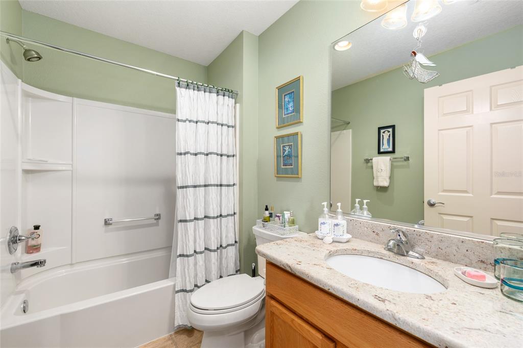 771 Fenwick Loop The Villages, FL 32163 - Photo 34 of 51 a bathroom with a granite countertop sink toilet mirror and bathtub