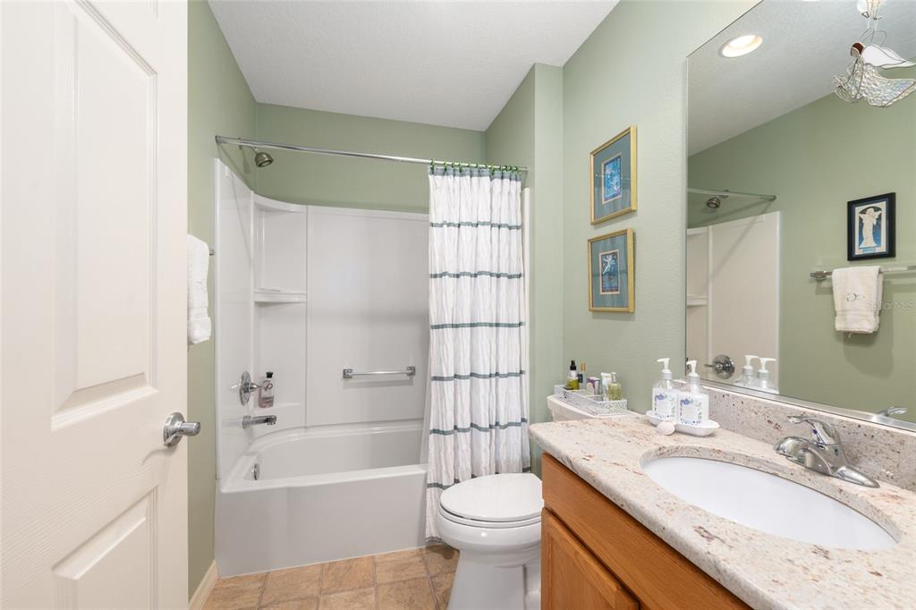 771 Fenwick Loop The Villages, FL 32163 - Photo 35 of 51 a bathroom with a granite countertop sink toilet and shower