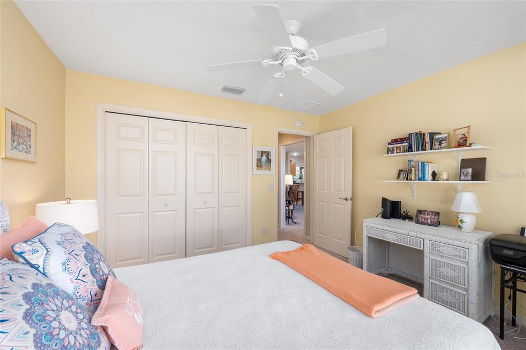 771 Fenwick Loop The Villages, FL 32163 - Photo 38 of 51 a bedroom with a bed and a chandelier