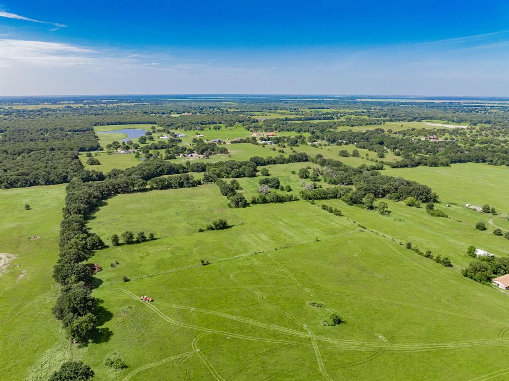 Lot 2 Co Road Kemp, TX 75143 - Photo 5 of 17 Expansive green pastures with mature tree lines, featuring scattered natural ponds and distant residential structures