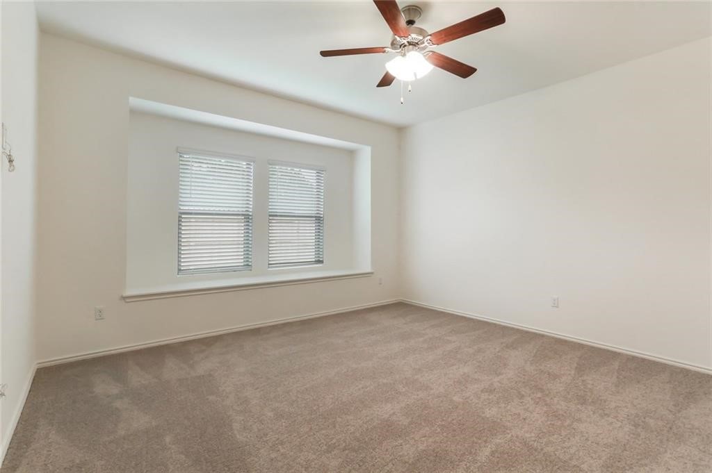 2233 Ringstaff Road Leander, TX 78641 - Photo 7 of 18 an empty room with windows and fan