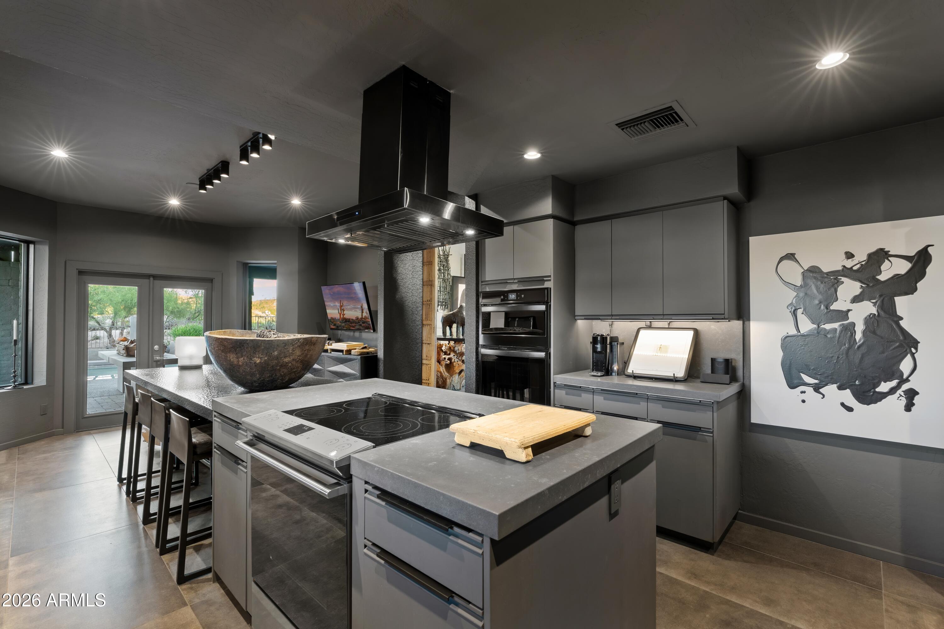 9545 East Romping Road, Unit 90 Carefree, AZ 85377 - Photo 24 of 59 a kitchen with stainless steel appliances kitchen island a stove and a refrigerator