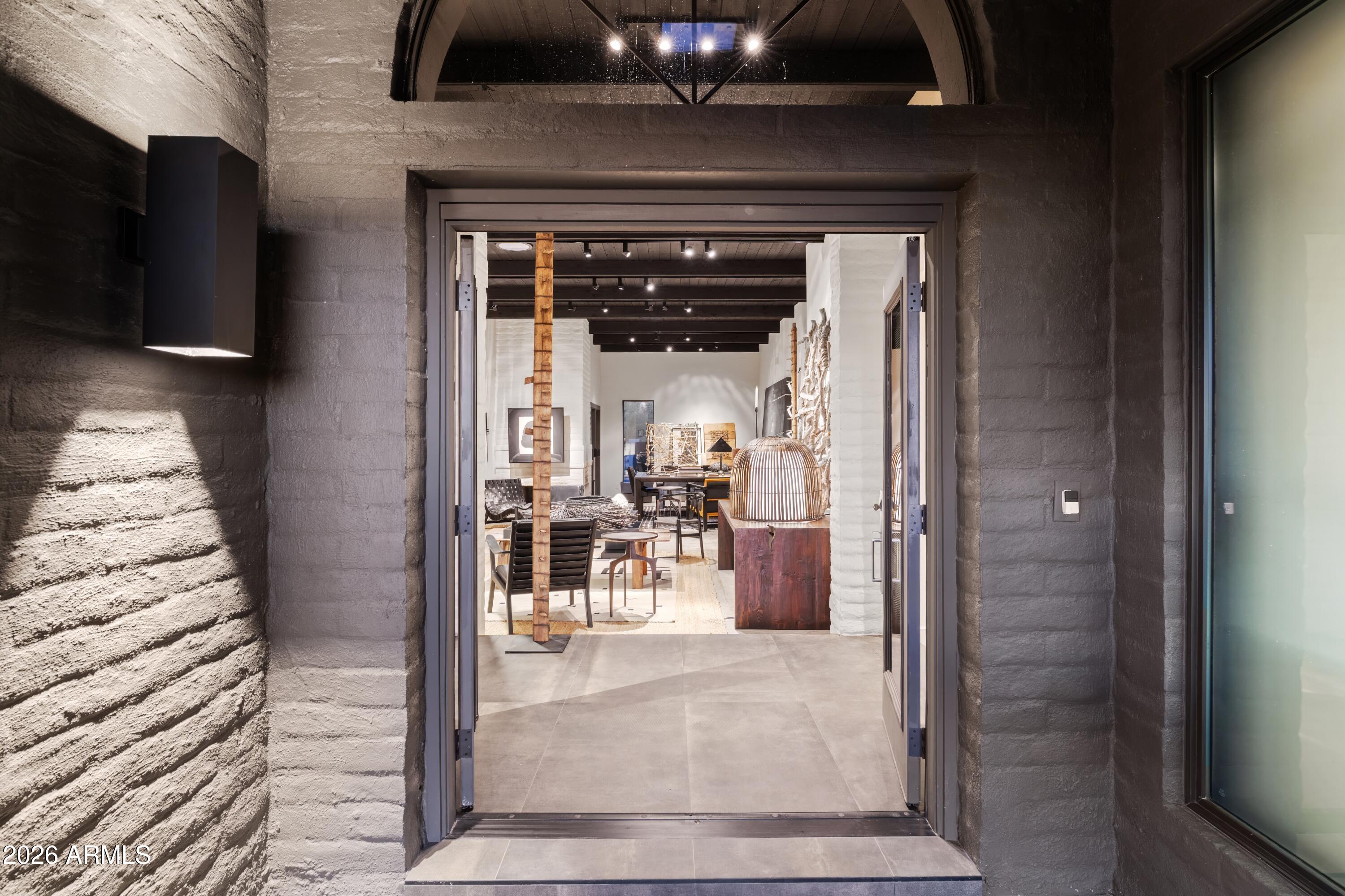 9545 East Romping Road, Unit 90 Carefree, AZ 85377 - Photo 7 of 59 a view of a hallway with dining area and chandelier