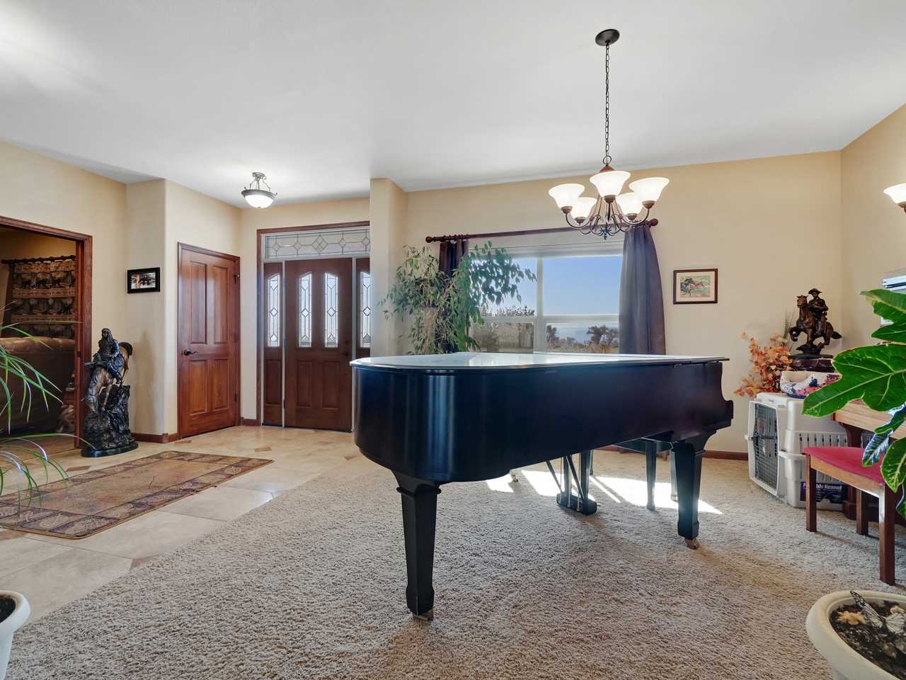 1421 19 Road Fruita, CO 81521 - Photo 17 of 36 a room with chandelier fan and a wooden floor
