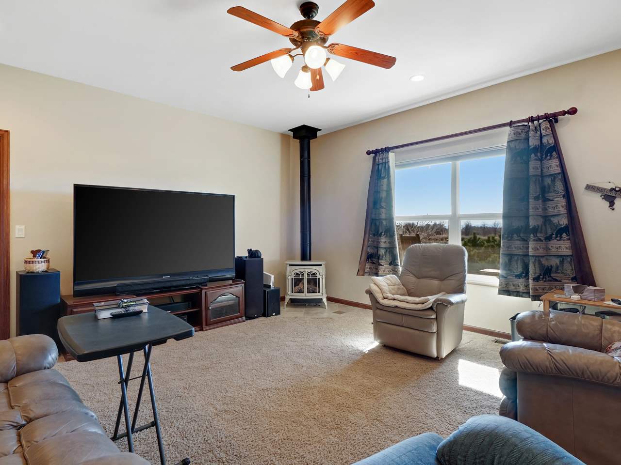 1421 19 Road Fruita, CO 81521 - Photo 24 of 36 a living room with furniture and a flat screen tv with wooden floor