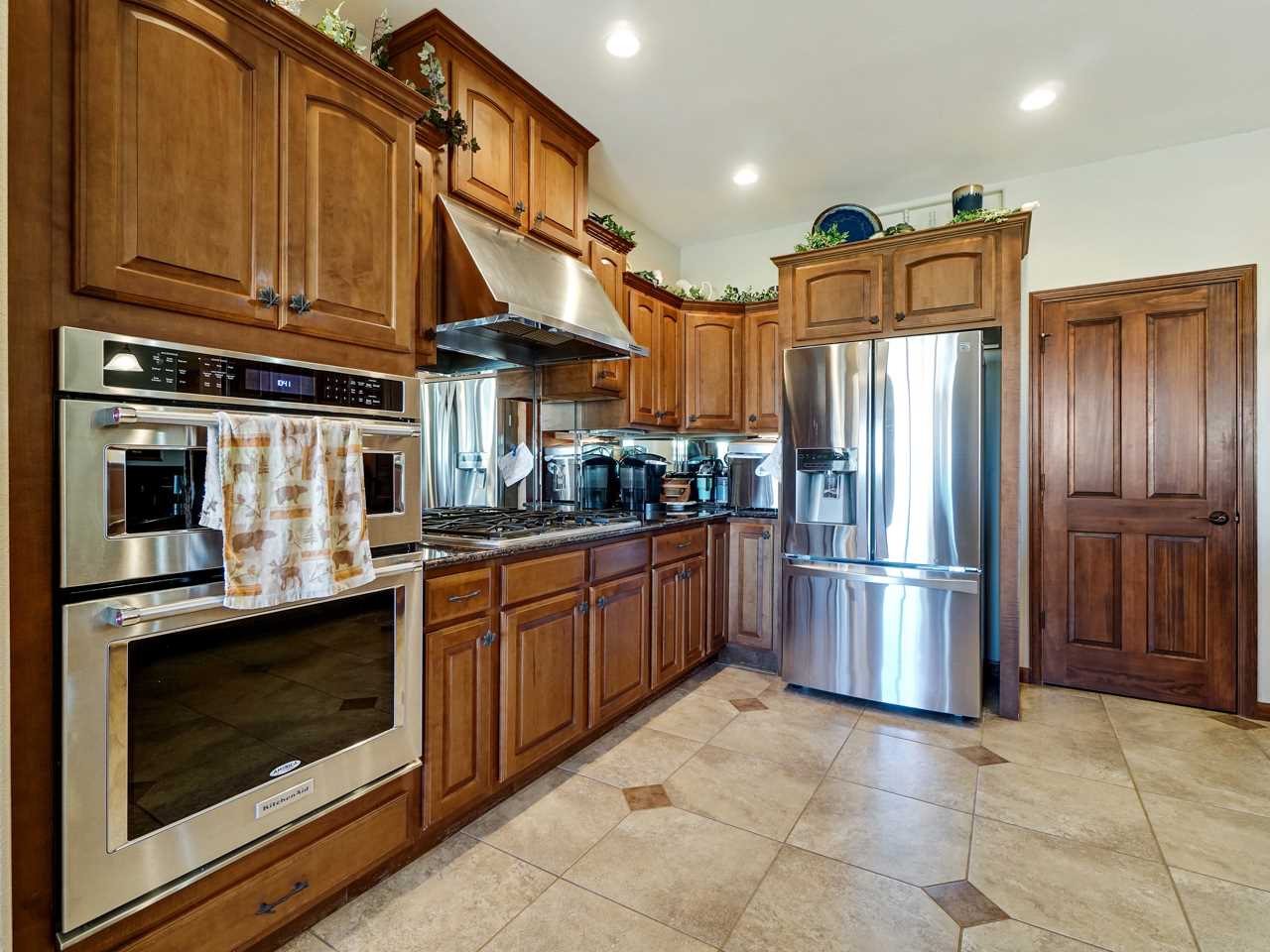 1421 19 Road Fruita, CO 81521 - Photo 26 of 36 a kitchen with stainless steel appliances granite countertop a refrigerator a stove and cabinets