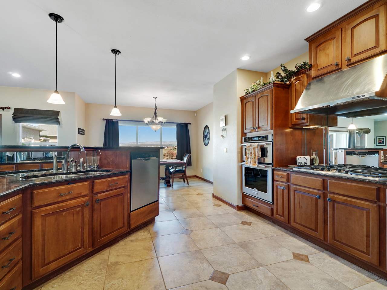 1421 19 Road Fruita, CO 81521 - Photo 27 of 36 a kitchen with stainless steel appliances kitchen island granite countertop a stove a sink and a refrigerator