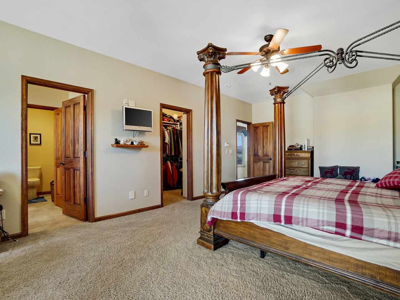 1421 19 Road Fruita, CO 81521 - Photo 29 of 36 a bedroom with bed and a chandelier