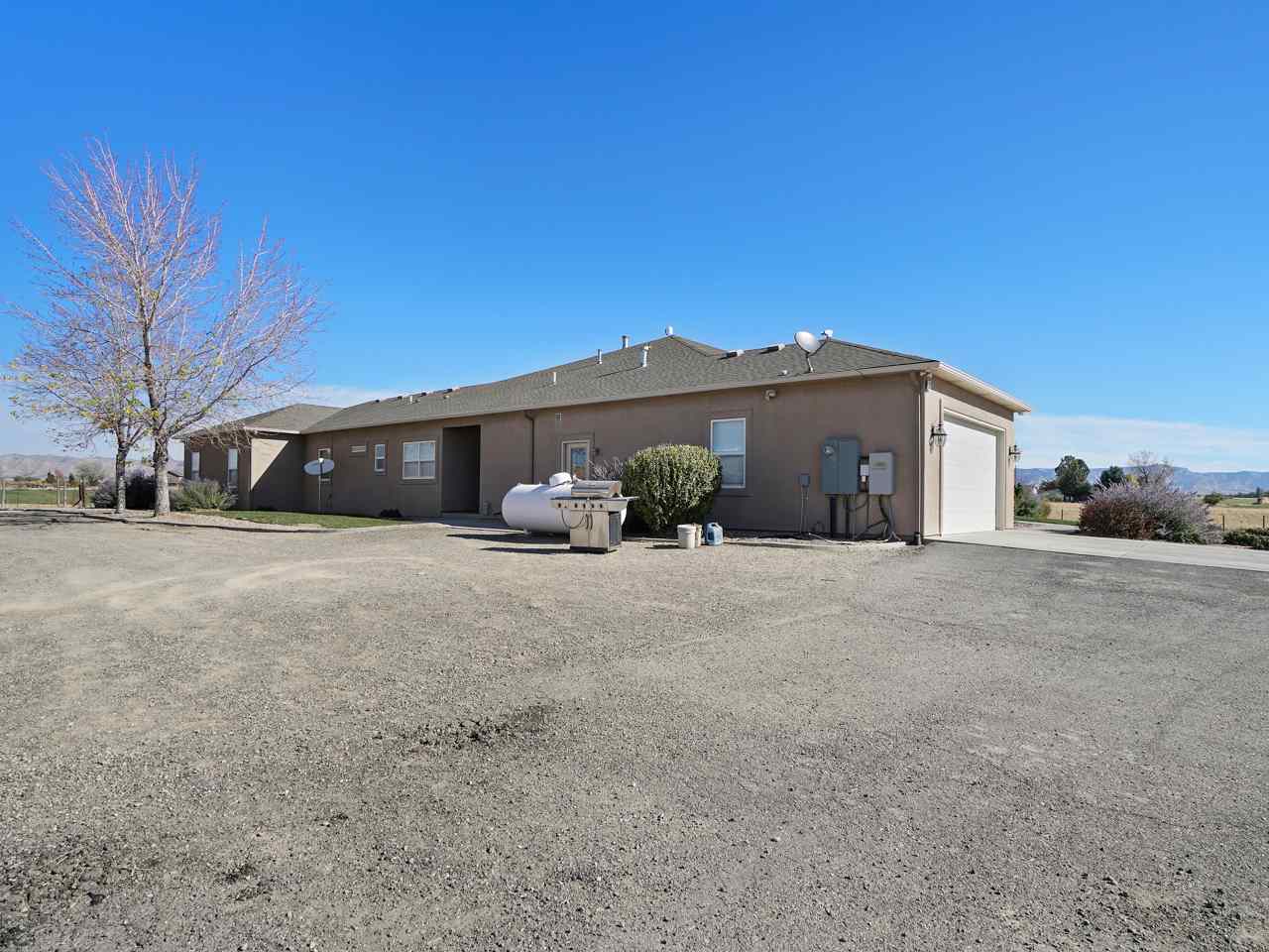 1421 19 Road Fruita, CO 81521 - Photo 6 of 36 a view of a house with a yard and garage