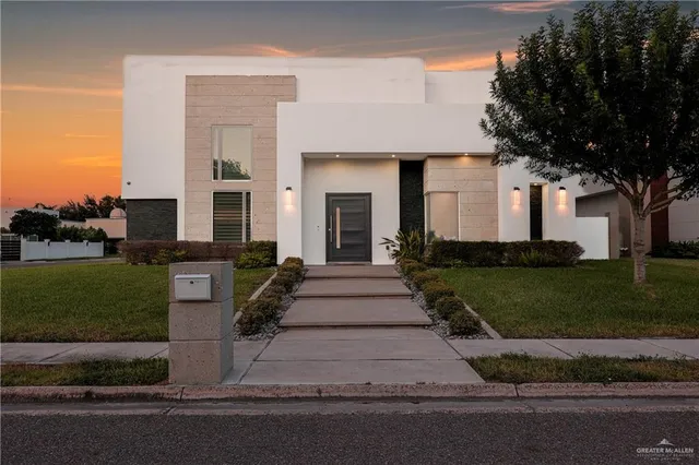 a front view of a house with a yard and a garage