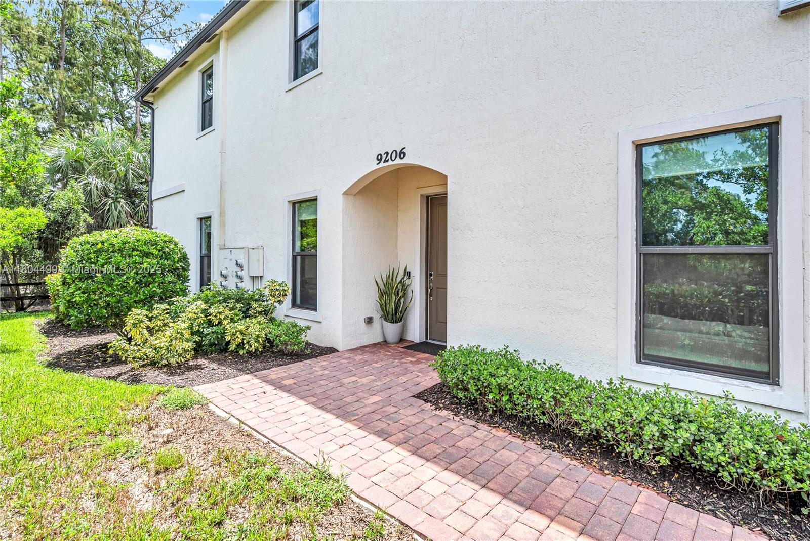 9206 Passiflora Way, Unit 101 Boca Raton, FL 33428 - Photo 12 of 60 a front view of a house with garden