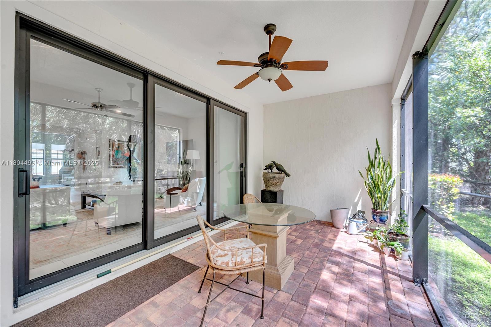 9206 Passiflora Way, Unit 101 Boca Raton, FL 33428 - Photo 16 of 60 a living room with patio furniture and a potted plant