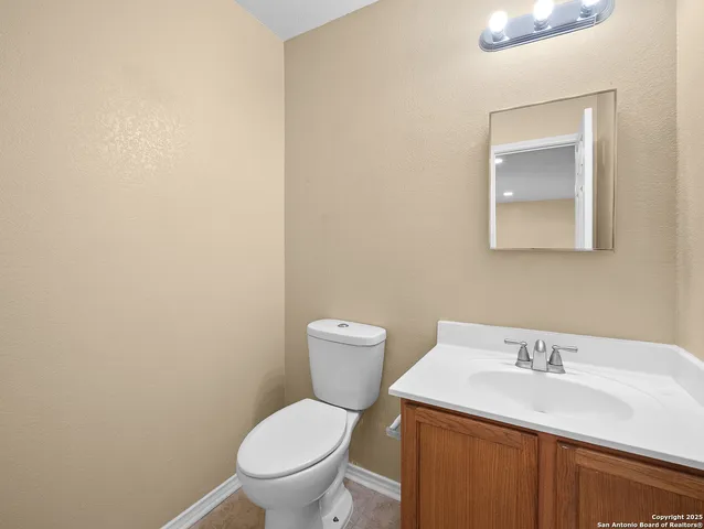 a white toilet sitting next to a bathroom sink