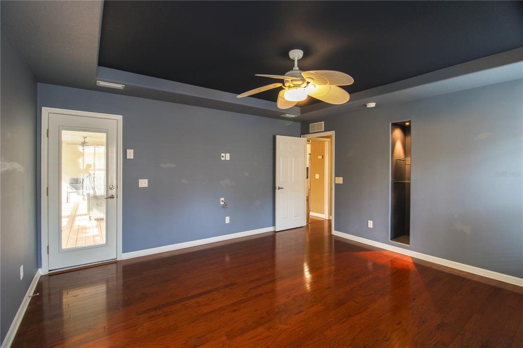 6065 Spruce Point Circle Port Orange, FL 32128 - Photo 14 of 33 wooden floor in an empty room with a window