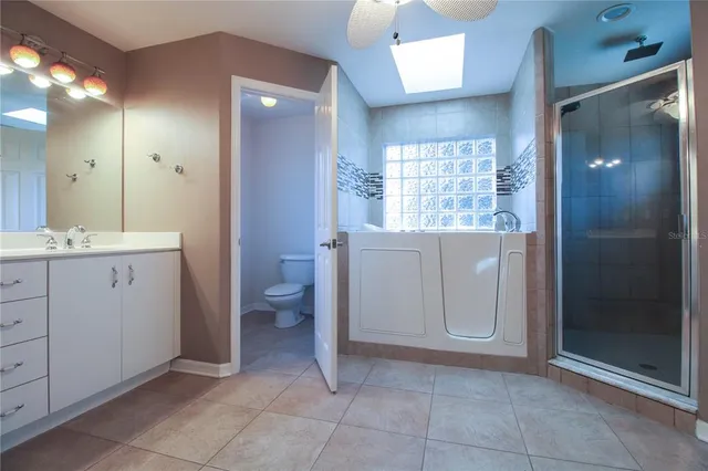 a view of bathroom with a toilet sink and mirror