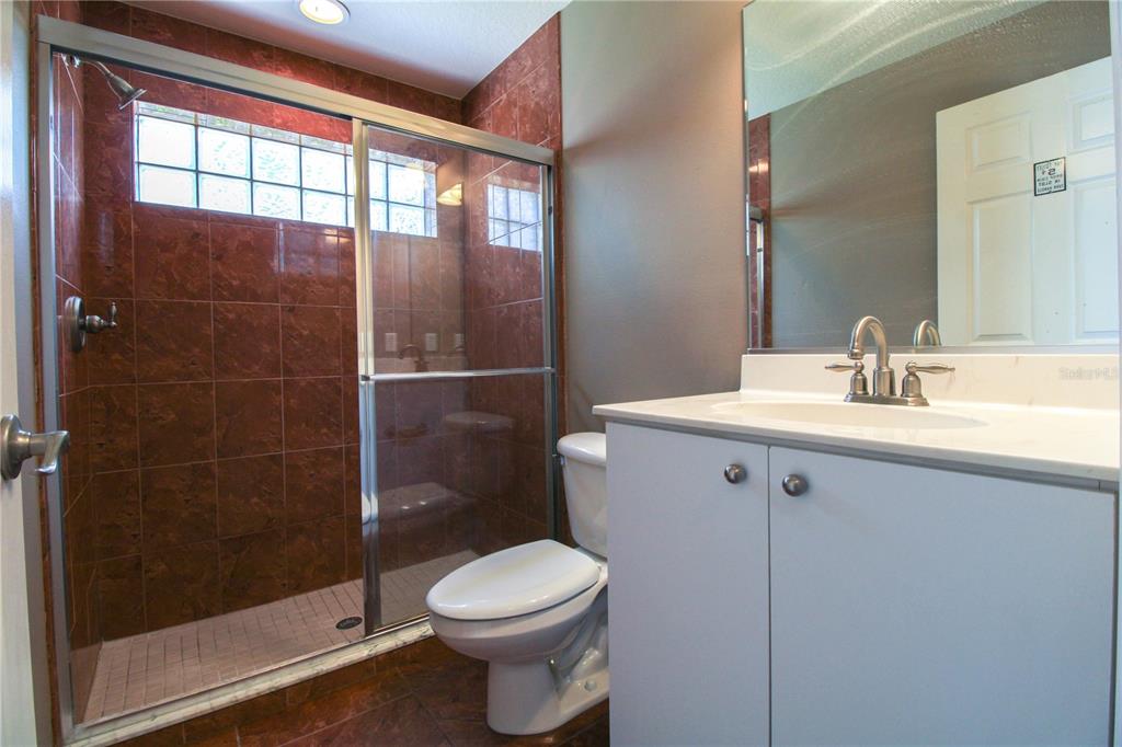 6065 Spruce Point Circle Port Orange, FL 32128 - Photo 20 of 33 a bathroom with a sink a toilet and shower