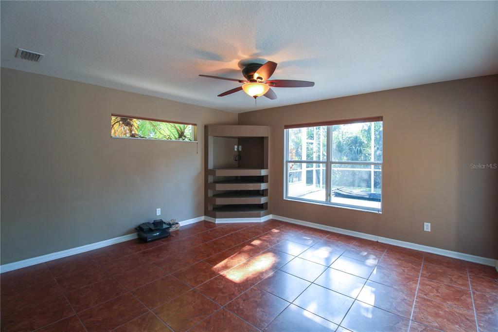 6065 Spruce Point Circle Port Orange, FL 32128 - Photo 21 of 33 a view of a livingroom with a ceiling fan and window