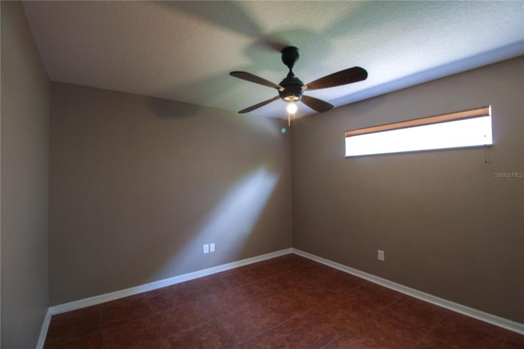 6065 Spruce Point Circle Port Orange, FL 32128 - Photo 23 of 33 an empty room with a window and a fan