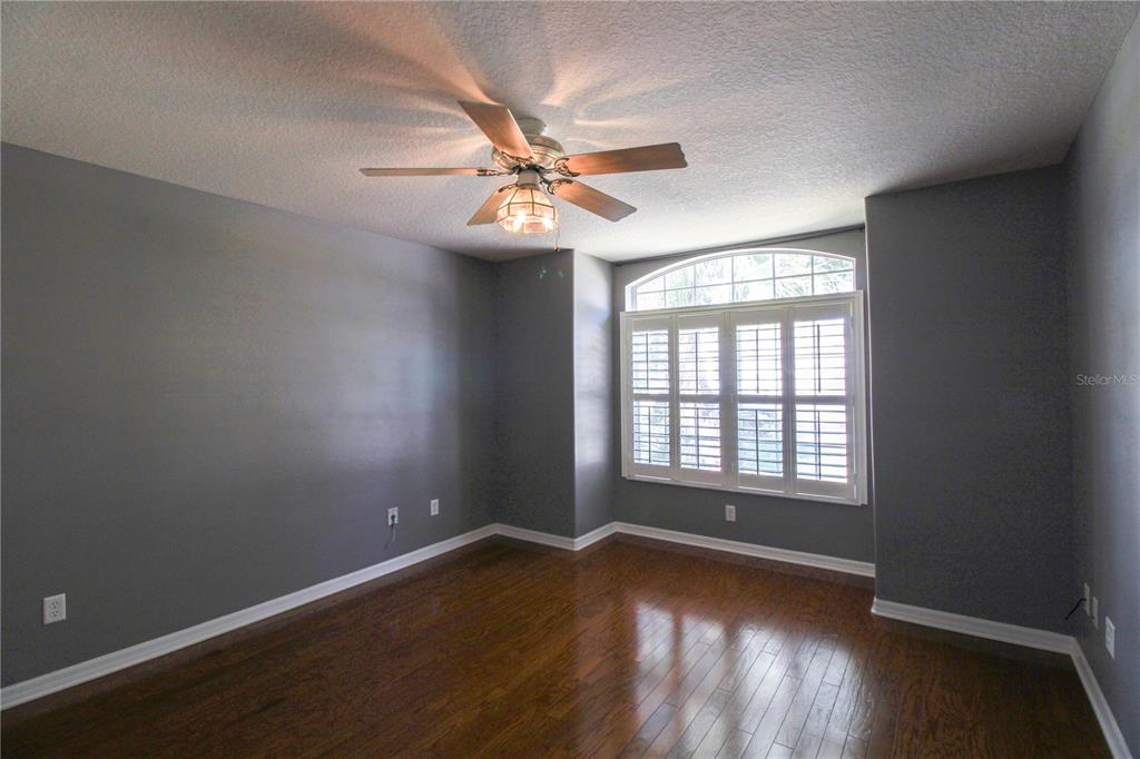 6065 Spruce Point Circle Port Orange, FL 32128 - Photo 6 of 33 wooden floor in an empty room with a window
