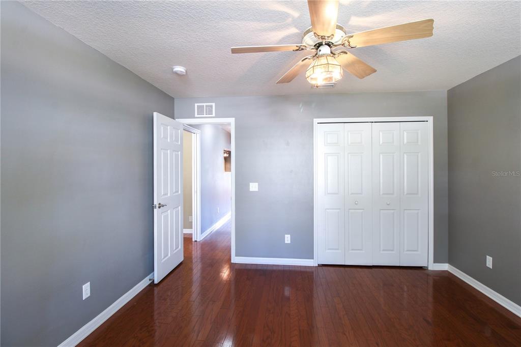 6065 Spruce Point Circle Port Orange, FL 32128 - Photo 7 of 33 wooden floor in an empty room with a window