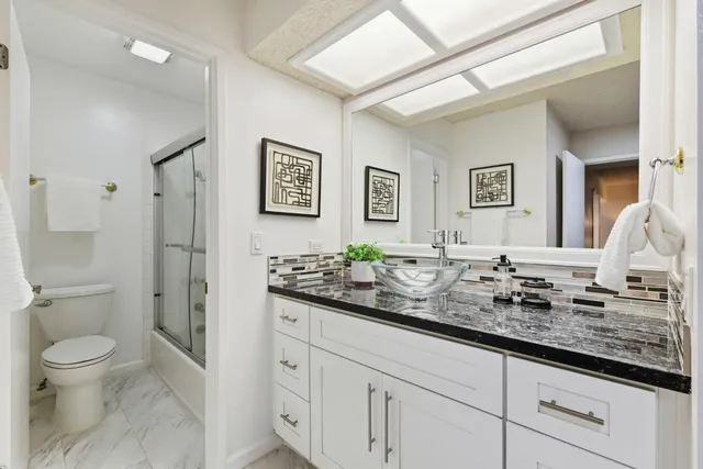 a bathroom with double sink and a mirror