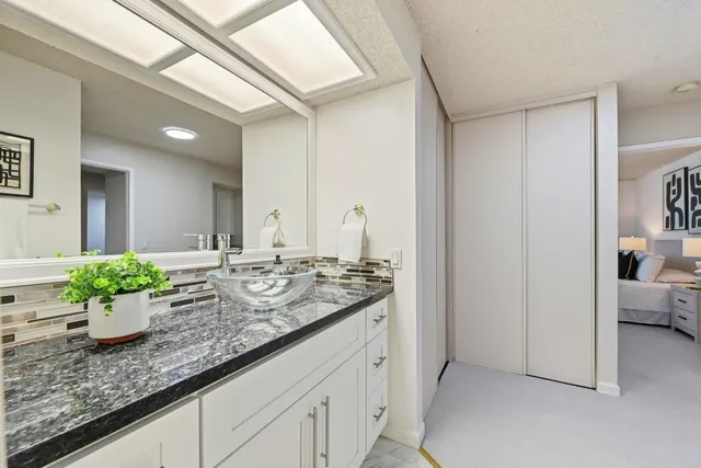a kitchen with sink and view of living room