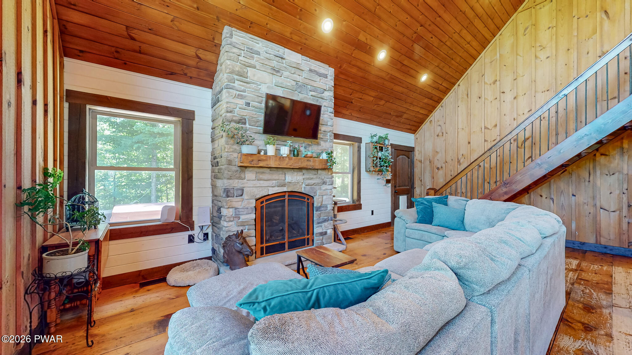 149 Sheards Road Milanville, PA 18443 - Photo 24 of 57 a living room with furniture a fireplace and a flat screen tv