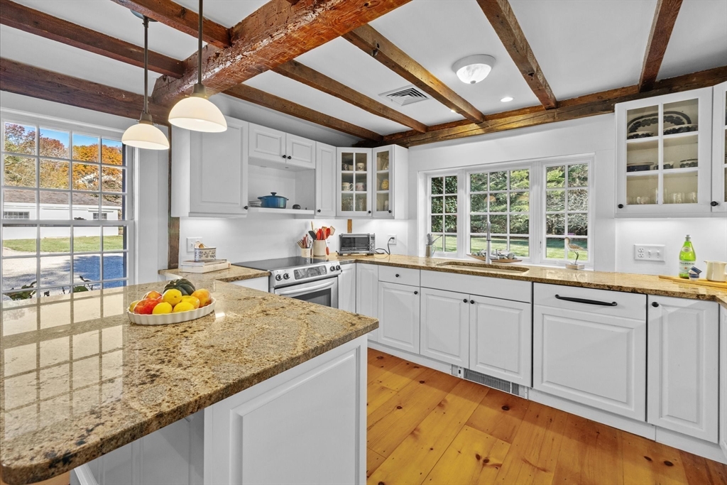 6 Rachael's Lane Duxbury, MA 02332 - Photo 12 of 42 a kitchen with a sink window and cabinets