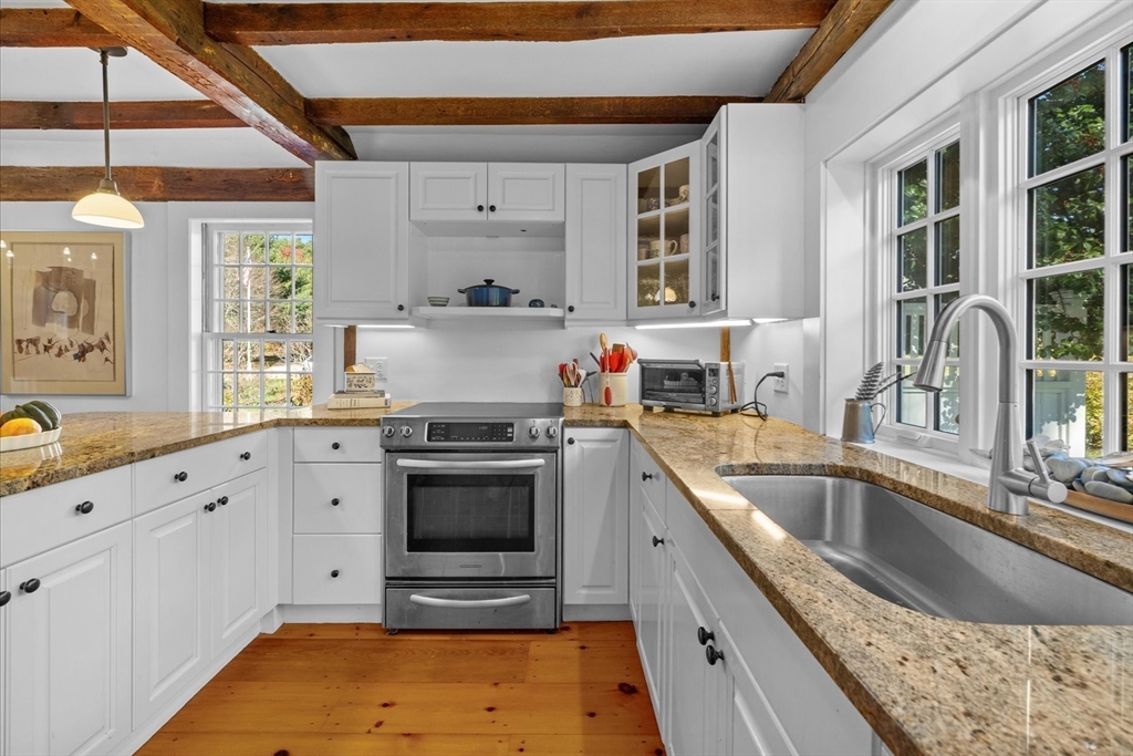 6 Rachael's Lane Duxbury, MA 02332 - Photo 13 of 42 a kitchen with granite countertop a stove sink and cabinets