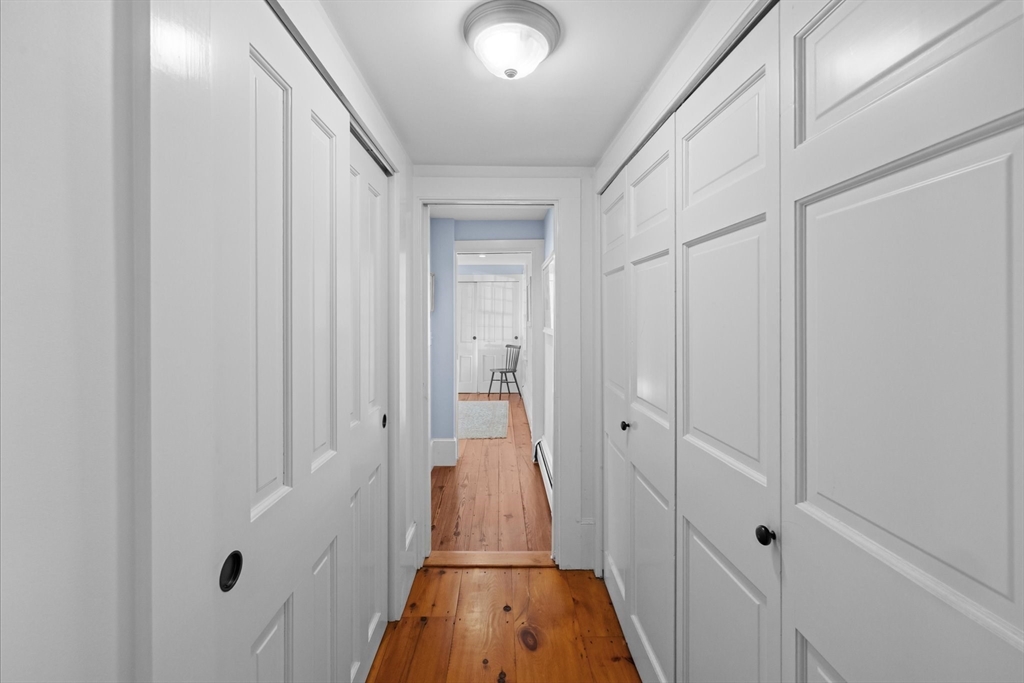 6 Rachael's Lane Duxbury, MA 02332 - Photo 18 of 42 a view of a hallway with wooden floor and closet area
