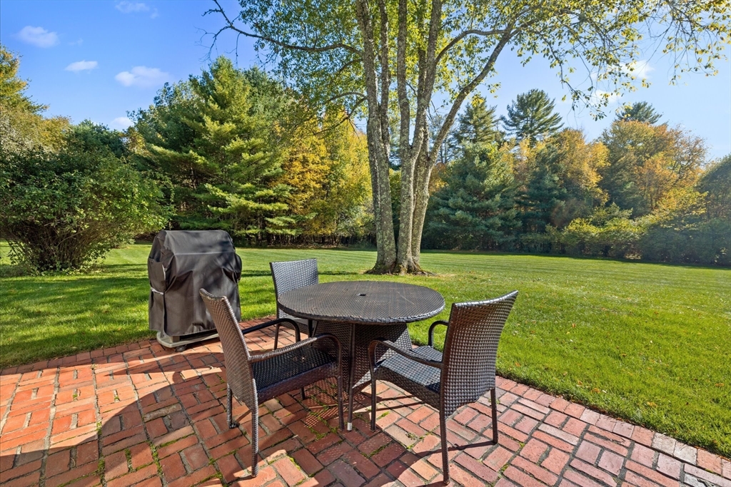 6 Rachael's Lane Duxbury, MA 02332 - Photo 32 of 42 a backyard of a house with table and chairs